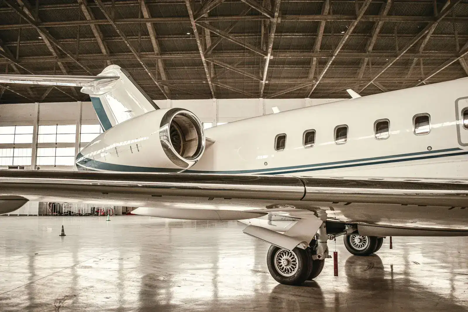 Business jet parked in a maintenance hangar
